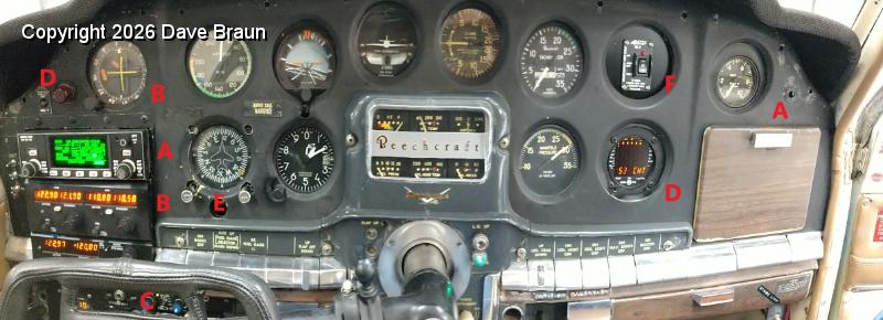 IMG_20191122_130745291 w key.jpg - Panorama view of interim panel. A- KLN 90B with update plug replacing Apollo LORAN; B- Narco MK12D with GS and ID825 CDI replacing Narco MK12D and ID824; C- Pitot Heat CB switch; D- EDM 711 CHT primary with remote caution lamp replacing single EGT probe indicator; E- Directional Gyro 52D54 replacing vertical card DG; F- AirTex ELT 345 remote switch replacing single digital CHT indicator.