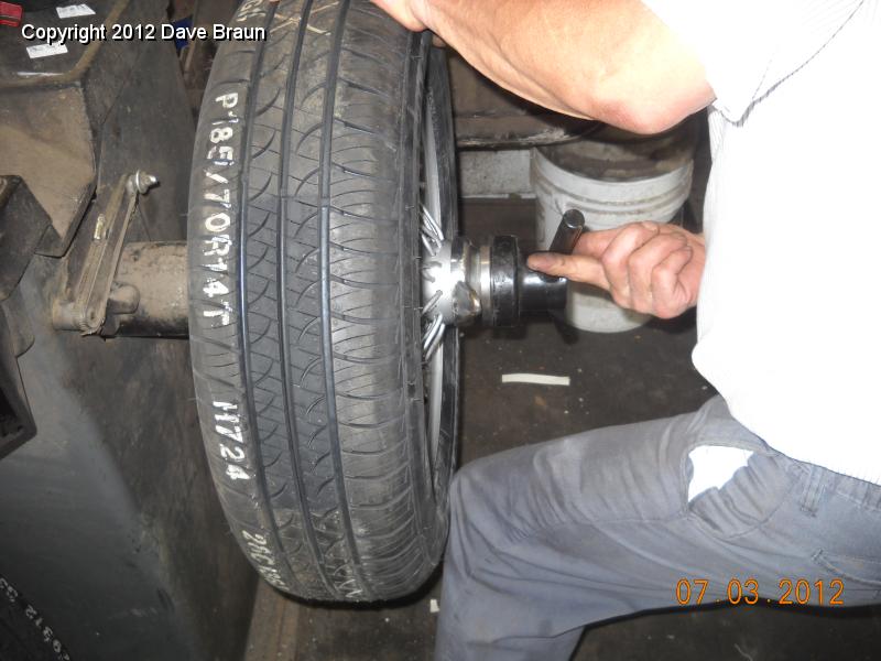 Using Cone adapters to balance wheels 01.jpg - Mike supplied the balancing cones Harvey is using here to balance the wheel/tire assembly.
