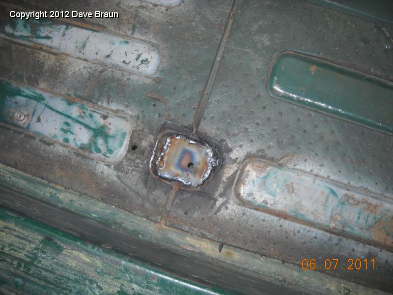 Welding up seat attach points in floor 08.jpg - Welded patch.