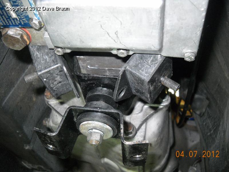 Ears to the rear and then install cross member and tilt into place and bolt.jpg - By installing with the 'ears to the rear' on the butterfly, and then installing the difficult to reach rear  bolts to the gearbox (closest to the overdrive) the cross member is installed, allowing the mounting rubbers to swivel into position. From here it is only a matter of selecting the front or rear mounting rubber holes in the cross member.