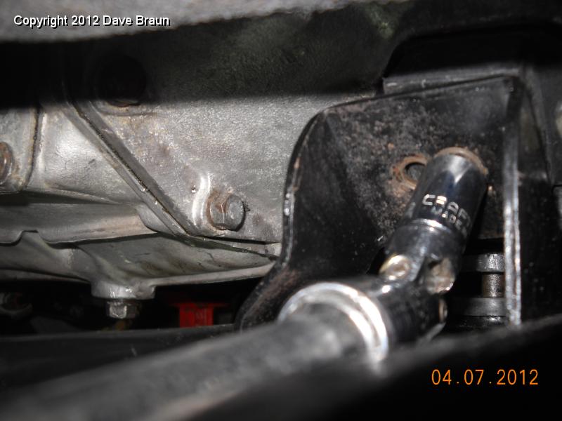 it didn't work with the OD to go with the rear hole 02.jpg - Showing the method of using a long 12 inch extension to tighten the gearbox mount to cross member bolts. I ended up though, installing the bolts in the front hole in the cross member. Here they are shown going into the rear holes.