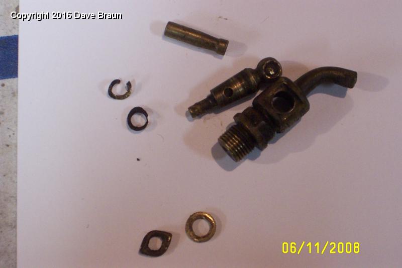 Block drain tap original.jpg - This is the original block drain tap. It was gunked up inside, and the handle broke off when I tried to open it. Next time a person should simply remove the tap, and carefully disassemble on the bench. However, the cotter on this one is also broken off, so I will drill a new cotter hole 90 degrees off the old. Mike Speidel will help me braze on the handle. I will use the spring from the 'new' tap which leaks.