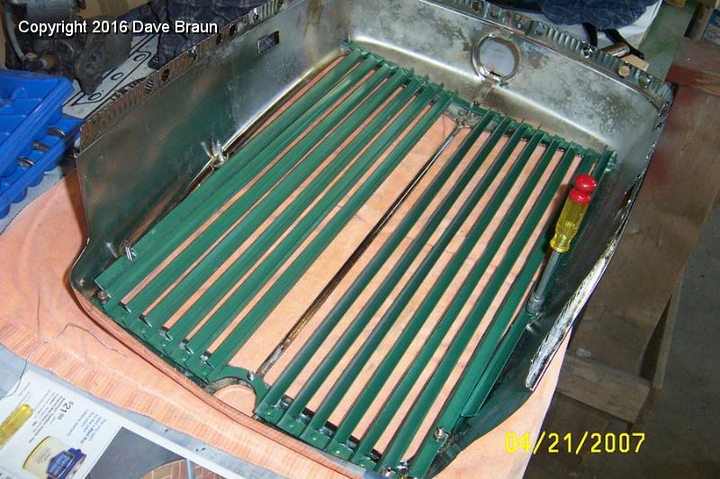 Installing grille.jpg - Installing the grille in the shell. After I polished the clear coat, I fitted the grille. I discovered I had to persuade some of the studs over, or the grill holes wouldn't line up. On the stud that was JB Welded, I just re-did it and waited overnight to torque it.