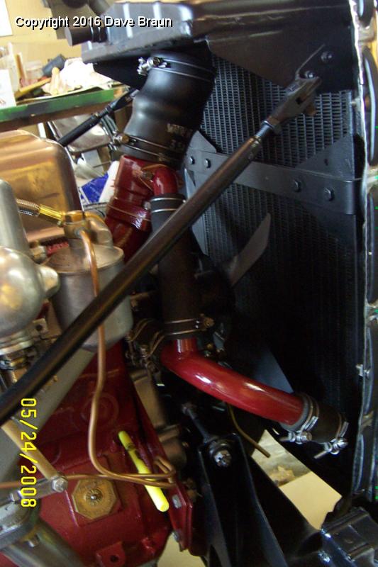 New hose in place marker plugs drain hole 2.jpg - New upper radiator hose installed and radiator stays re-fastened. Notice the bright marker pen threaded into the block drain location so the coolant won't continue to drip while I ask my supplier to replace the drain cock under warranty.