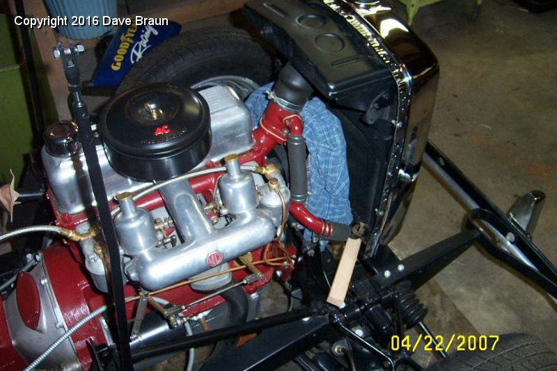 Protecting radiator from fan and shims to mount hardware.jpg - I used shims to support the assembly. The shims got the mounting bolts away from the steering rack so I could install the lower mount, the thick fender washer, and the two locking nuts. I did end up removing the front bumper. I hung them on the car to keep them safe, but they were in the way when installing the radiator. I'll take them off again when I install the front valance.