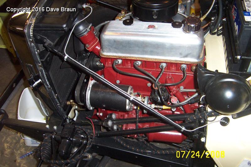 Water temp bulb.jpg - Here is the routing of the water temp capilary tube. It travels straight with no coils to the radiator stay (the radiator and the stay are stationary, If the bulb was in the engine, coiling the tube would be a good idea) and then into the small grommet on the firewall. I lowered the level of coolant in the radiator, and removed the temporary plug, and installed the temperature bulb.