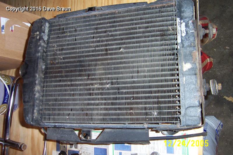 rad exposed front side.JPG - Radiator exposed. I can straighten the fins with a fine screw driver blade. Sounds tedious, but it only took a few minutes. It also allowed me to push out the larger remenents of grime and dead bugs.