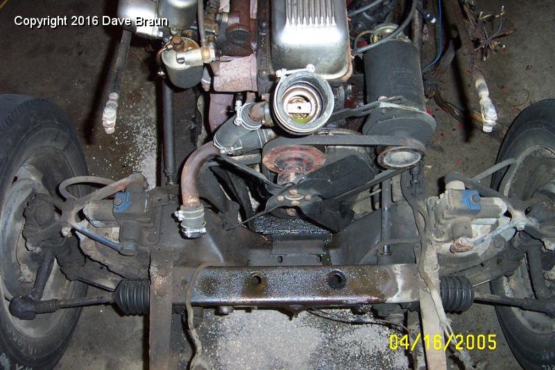 Radiator mount location 2.JPG - An upper view of the cross brace mount. Notice that the brace mounts below the dumb irons, and the large mounting holes go aft.