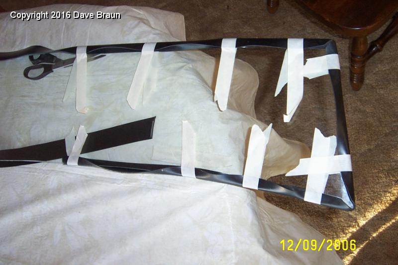 Measuring and mitering the gasket.jpg - Measuring and mitering the gasket. I decided to miter the corners of the gaskets. I put the finished piece in the frame prior to installing the glass, and cut the excess off the bottom edge just before installing the bottom frame.