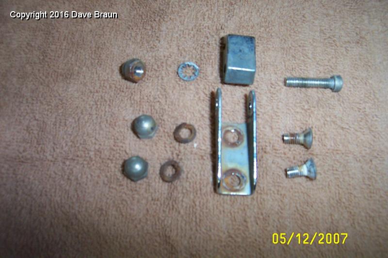 Windwing hardware.jpg - Wind wing hardware. I replaced all the split washers. I cleaned with 00 steal wool all the fastners and chrome parts. On the locking clamp bracket, two of them were never chromed. I painted these two with aluminum metalic paint, and gave them a shot of clear enamel.