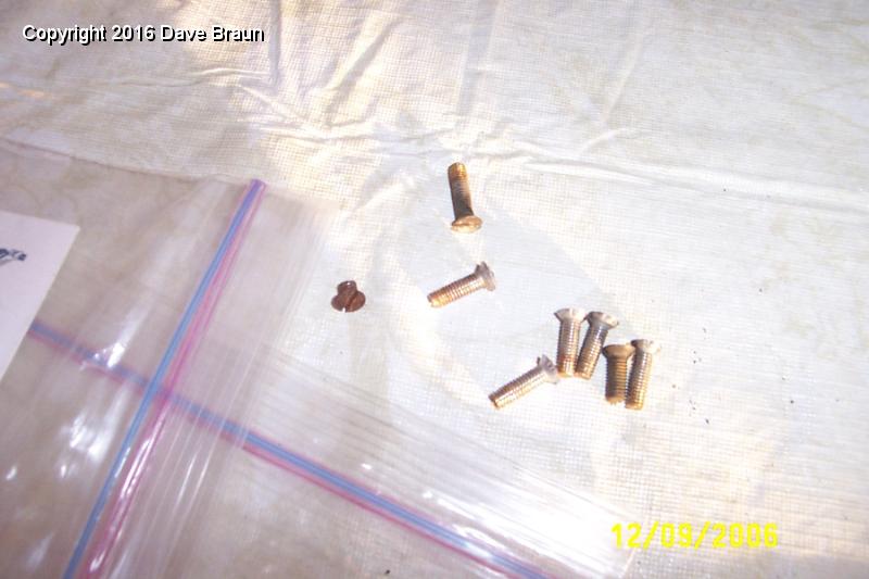 some of the old screws.jpg - The old screws. Quite a mishmash of screw heads and conditions. I ordered a new set, along with one bottom angle bracket. The good angle bracket was new about three years ago (yes, I only replaced one at the time!)