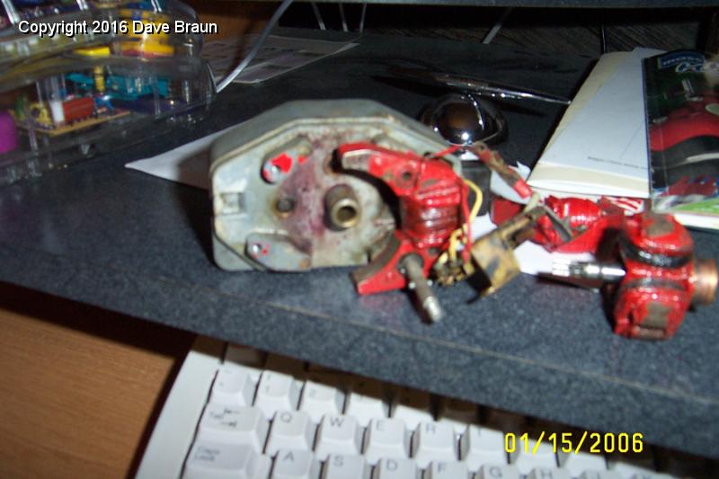 inside motor part of wiper motor.JPG - Motor parts. Pretty simple, two magnets, two brushes, three coils, and a bunch of brittle wire. The armature is also shown.